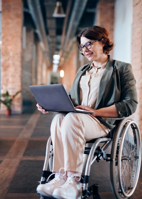 Woman in wheelchair using computer